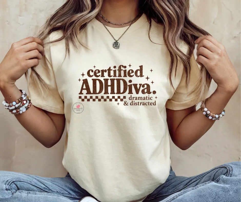 Certified ADHDiva in brown font on Ivory/Natural Tee by When Pigs Fly Goods